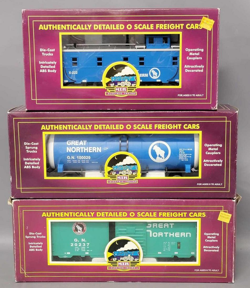 Three MTH O Gauge train cars in original boxes: Three MTH O Gauge train cars in original boxes, includes 91016 Great Northern Steel Caboose, 96027 Great Northern Tank Car and 93014 Great Northern 40 foot single door box car, all are excellent C7 wi