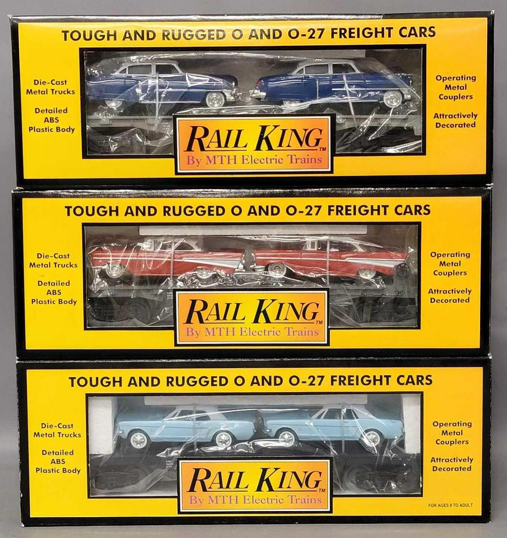 Three Rail King O Gauge MTH Auto transport flat car with ERTL cars in original boxes: Three Rail King O Gauge MTH Auto transport flat car with ERTL cars in original boxes, includes 7607L with 1952 Cadillacs, 7617 with 1964 Mustangs and 7610 with 1957 Chevys, all appear C7-8 with little