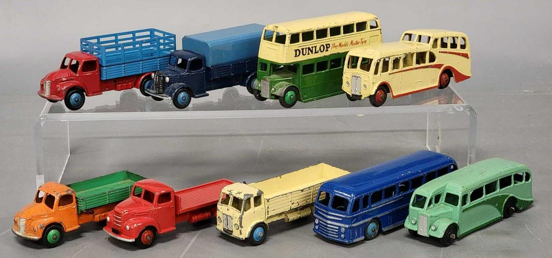 Nine Dinky Toys trucks and large vehicles: Nine Dinky Toys trucks and large vehicles, includes Duple Roadmaster Leyland Royal Tiger blue bus, Dunlop advertising double decker bus, tan Observation coach, a two tone half cab bus,, a red and blue