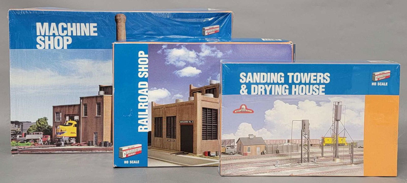 Three Walthers Cornerstone HO model train kits in original boxes: Three Walthers Cornerstone HO model train kits in original boxes, includes 2 Machine Shop, 2970 Railroad Shop and 3182 Sanding Towers & Drying house, the sanding towers and machine shop are still