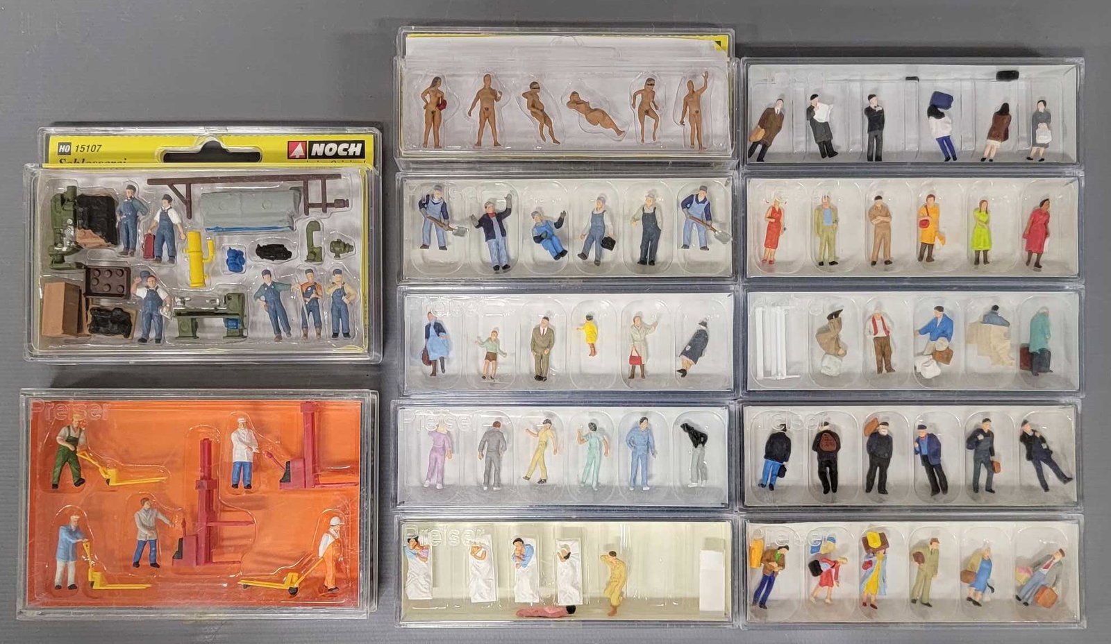 Twelve Preiser HO scale figure packs in original boxes: Twelve Preiser HO scale figure packs in original boxes, includes standing passersby, industrial and dock workers, transition era freight train crew, passengers on beds for sleeping car, waiting passen