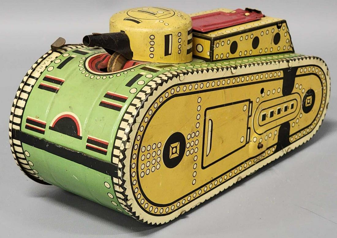 Vintage 1930's Louis Marx Doughboy Wind up Tank Toy: Vintage 1930's Louis Marx Doughboy Wind up Tank Toy, tank is light yellow , green and red, it is in very good condition with light wear in spots, appears complete, it does have a couple of minor d