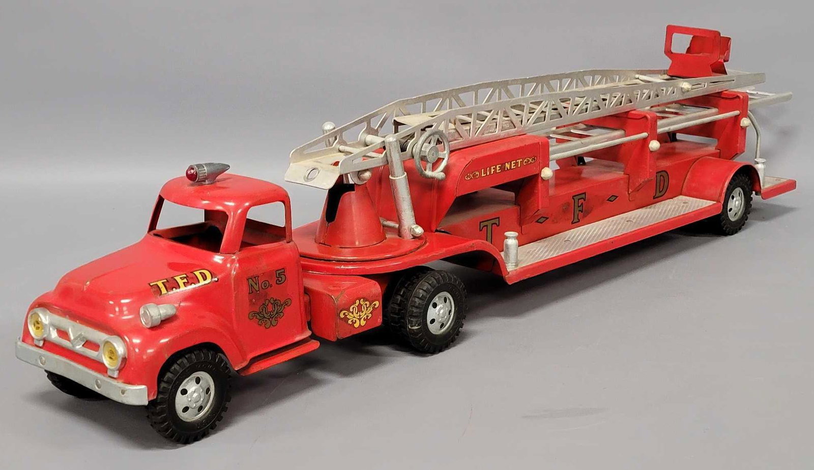 1956 Tonka hook and ladder fire truck: 1956 Tonka hook and ladder fire truck, played with condition with one of the loose ladders as seen in the photos.