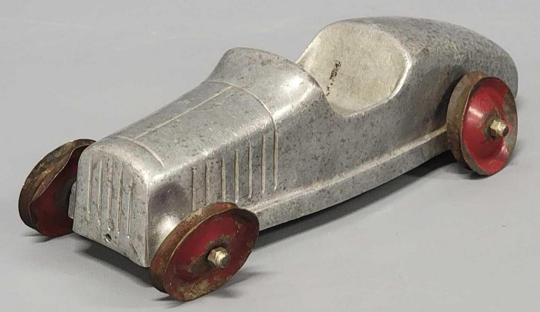 Vintage rare cast aluminum Toldeo Racer: Vintage rare cast aluminum Toldeo Racer, car measures 11 1/4 inches long, 2 3/4 inches wide and 3 inches tall at the windshield, the body is in excellent condition with no cracks or nicks, the wheels 