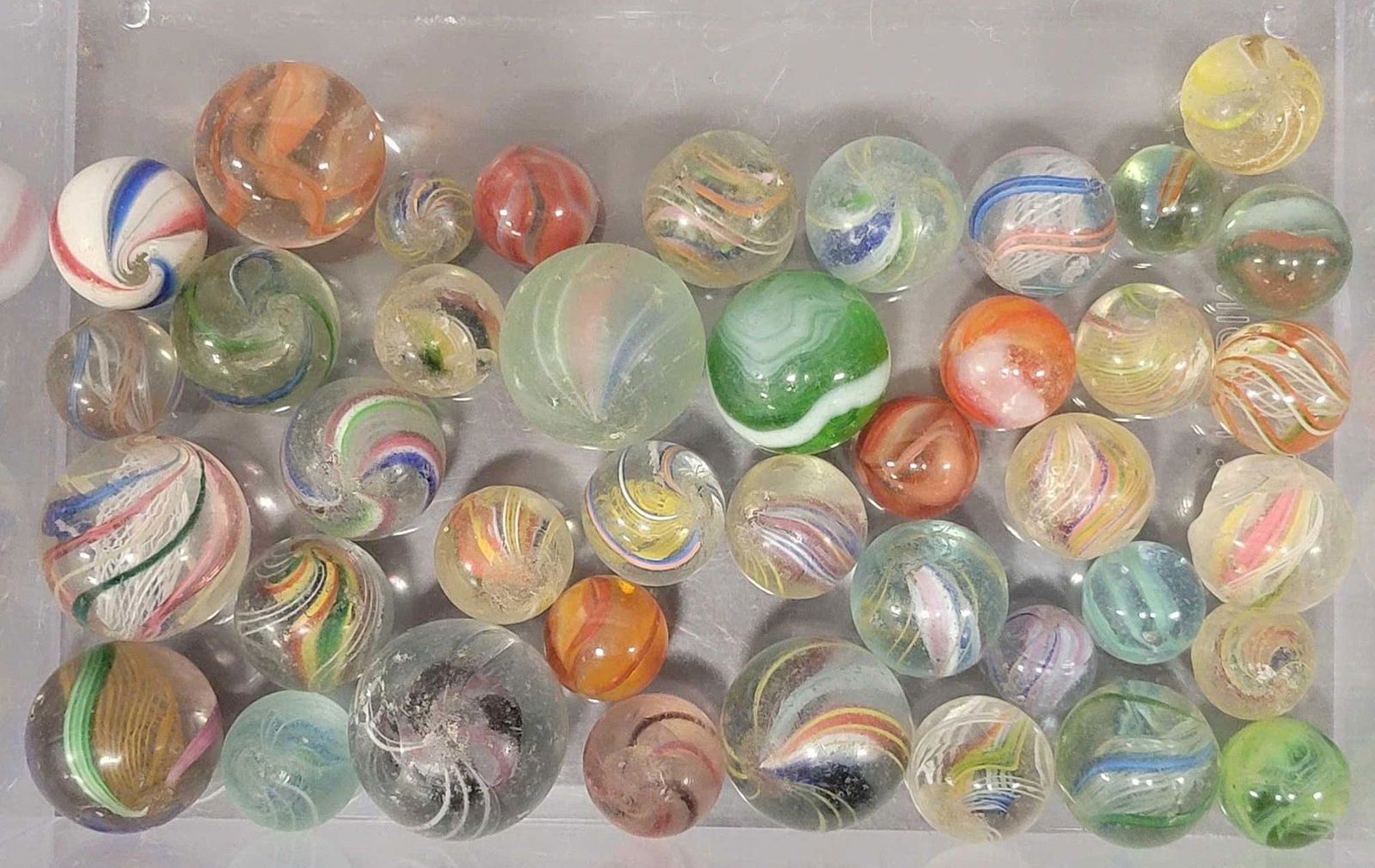 Collection of forty plus vintage marbles including candy stripes swirls onion skins (1 of 4)