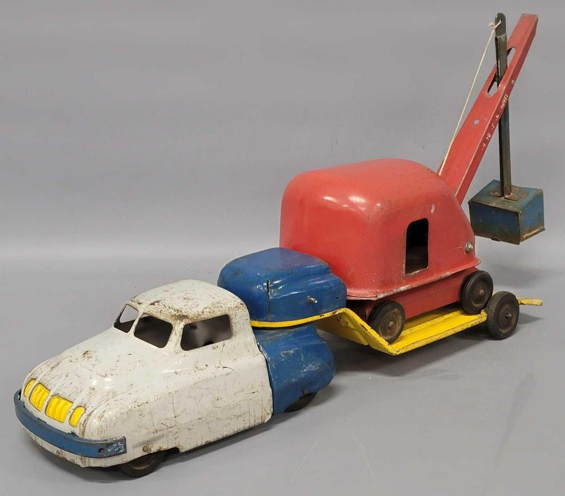 Wyandotte 1930s lowboy truck with steam shovel: Wyandotte 1930s lowboy truck with steam shovel, both pieces are well played with but no major dents or issues, as seen in the photos.