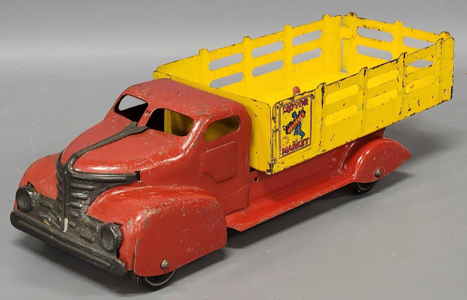 Marx 1930s stake bed motor market truck: Marx 1930s stake bed motor market truck, this one has what seems to be a little less common yellow stake bed rails, most you find are blue, it appears complete in played in condition, as seen in the p