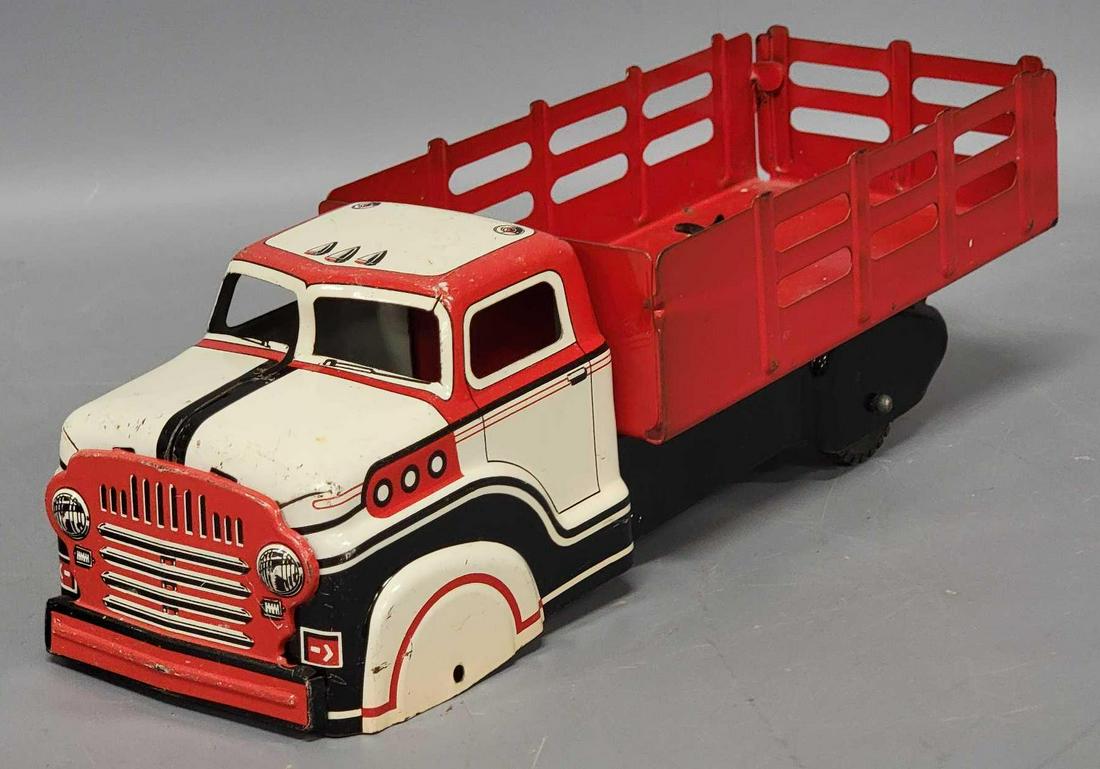 Marx pressed steel litho Dodge cab stake bed truck: Marx pressed steel litho Dodge cab stake bed truck, truck has light playwear overall but is missing its front axle and wheels, as seen in the photos.