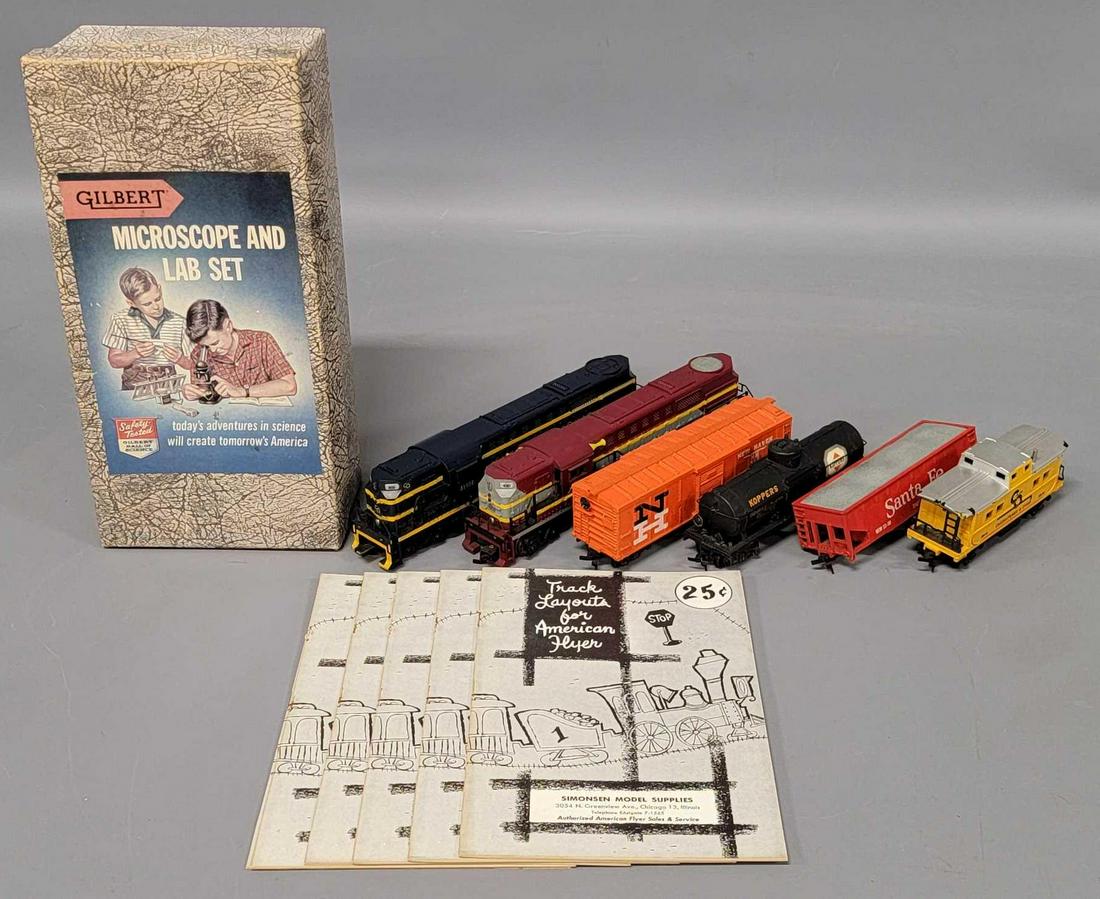 Group of Gilbert American Flyer HO trains and paper: Group of Gilbert American Flyer HO trains and paper to include 31022 Chesapeake and Ohio and 430 Alco Fairbanks Morse trainmaster units with some railing damage, four fright cars (one missing a set of