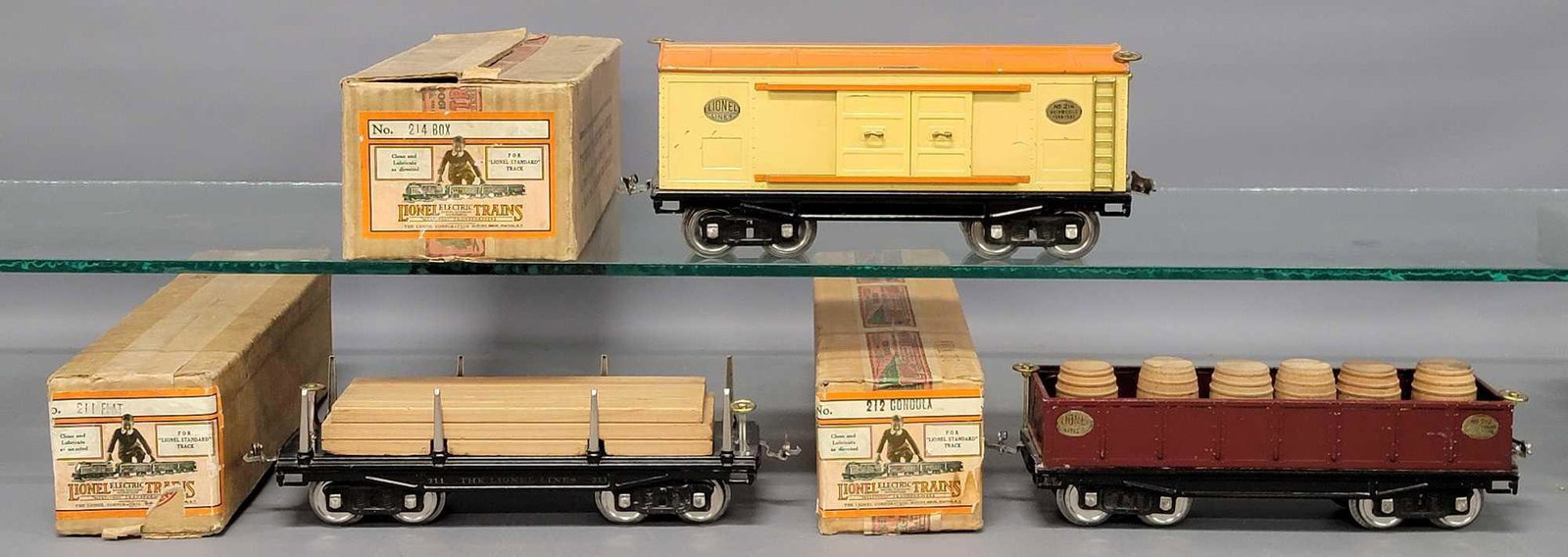 Lionel prewar standard gauge 211 212 214 freight in original boxes: Lionel prewar standard gauge 211 flat car with lumber load, 212 wine gondola with six two-piece wooden barrels and 214 box car freight in original boxes, C6+ to C7 in very nice original boxes with