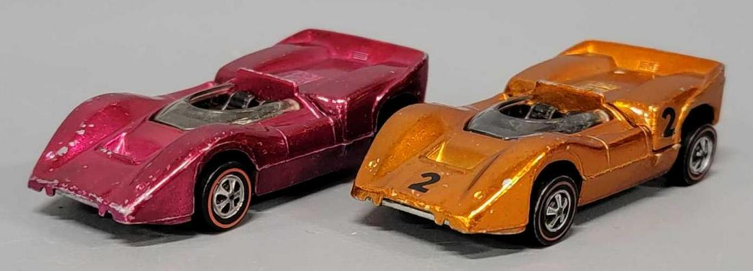 Two Redline Hot Wheels McLaren M6A: Two Redline Hot Wheels McLaren M6A race cars, one orange and one rose. Sold as-is as seen in the photos with no returns.