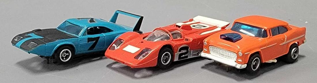Three vintage AFX HO slot cars: Three vintage AFX HO slot cars to include 1955 Chevy Bel Air, blue Dodge Daytona Superbird and Ferrari 512, all three are in excellent or better condition as seen in the photos. All three have been te