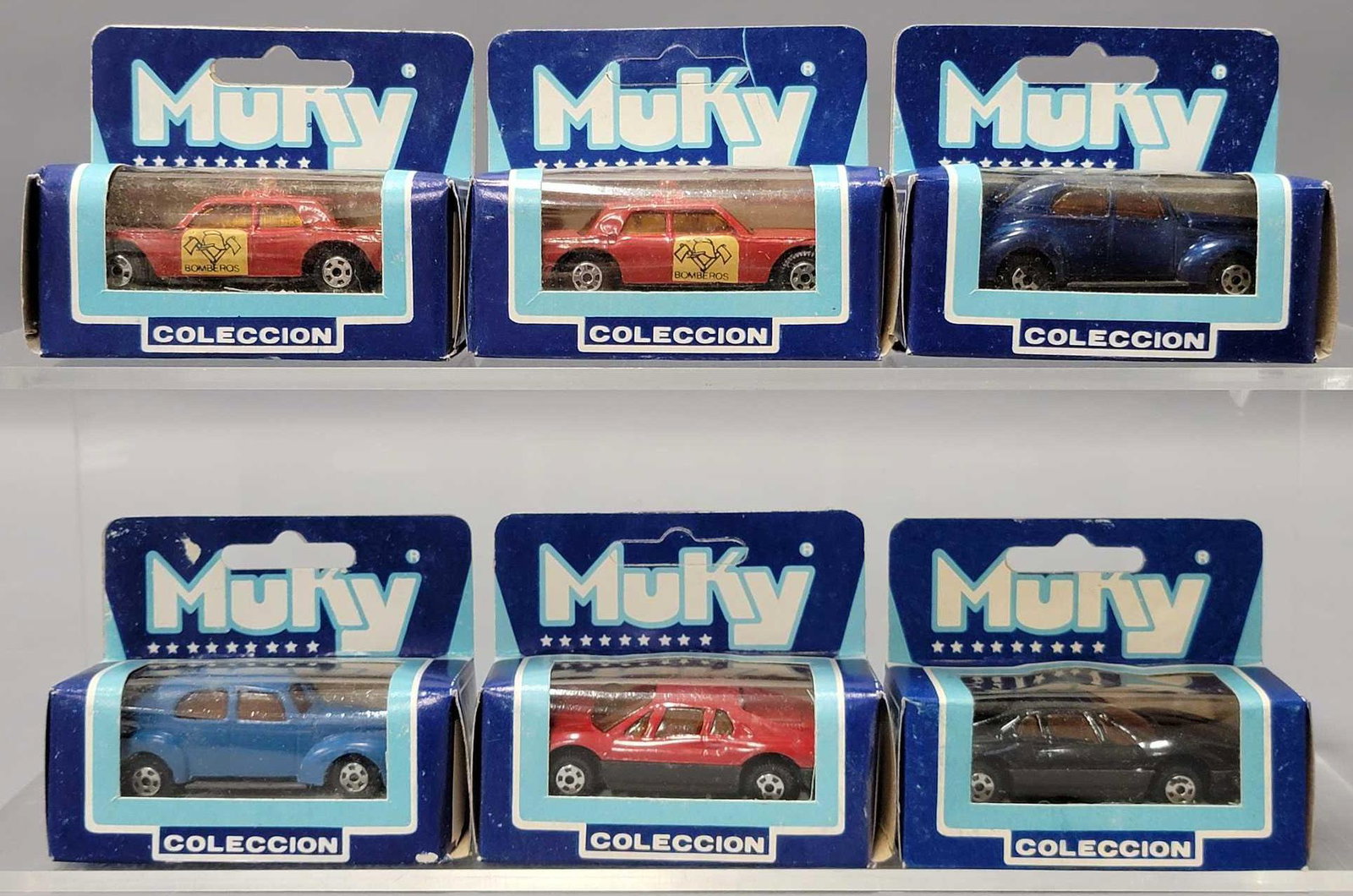 Six Muky 1/64 die cast cars in original boxes: Six Muky 1/64 die cast cars in original boxes to include two Bomberos, two different 1941 Ford sedan and two different Ferrari, all near mint to mint in very good to excellent original boxes as seen i