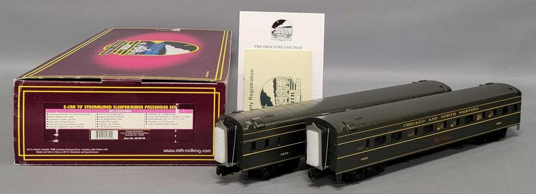 MTH Premier 20-66129 C&NW 70' streamlined passenger car set in original box: MTH Premier 20-66129 Chicago and Northwestern 70' streamlined passenger car set in original box. Set consists of one sleeper and one diner car, these show moderate run time and are C8+ in an e