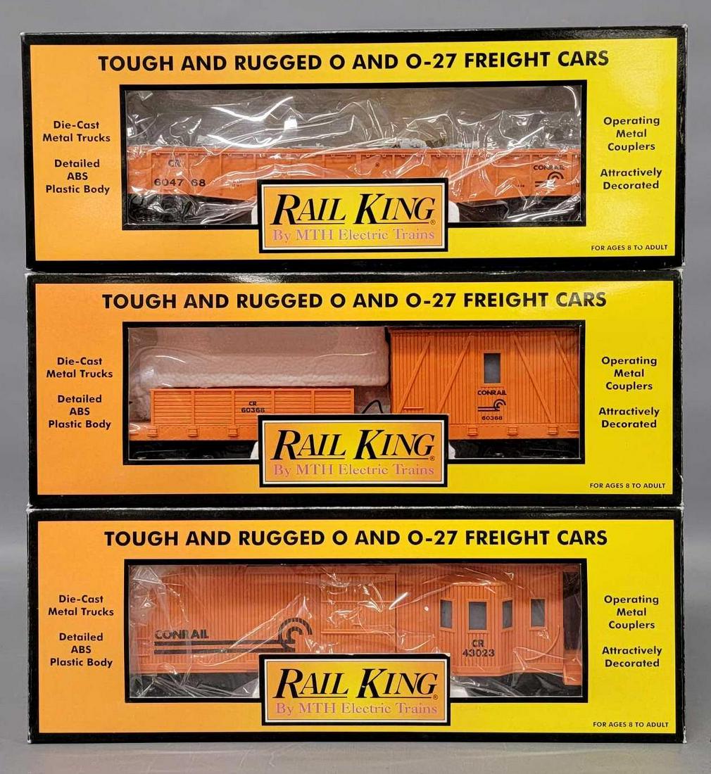MTH Rail King O gauge Conrail cars in original boxes: MTH Rail King O gauge Conrail cars in original boxes to include gondola with junk load (small chip out of one piece of the junk load), crane tender car that is cracked in half right through the middle