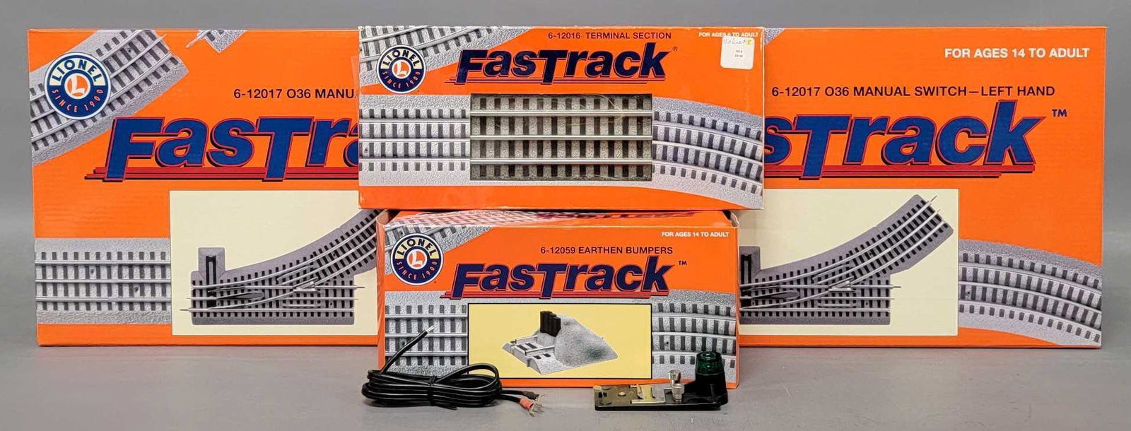 Group of Lionel Fastrack switches bumpers and terminal in original boxes: Group of Lionel Fastrack switches, bumpers and terminal in original boxes. Includes two 12017 left hand manual switches, 12059 two earthen bumpers, one 12016 terminal section and an LTC terminal plus 