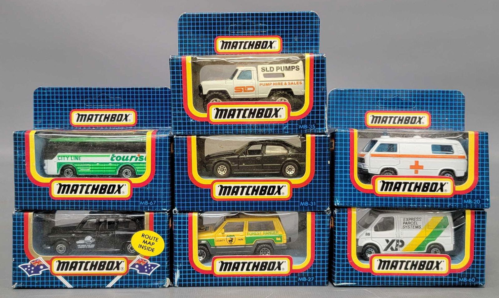 Seven Vintage Matchbox Group: Seven Vintage Matchbox Group. Express Parcel Systems Ford transit that is not sealed, Volkswagen Transporter, Jeep Cherokee, BMW Serie 5, SLD 4 x 4 Camper Truck, Ikarus Coach, and London Taxi as seen