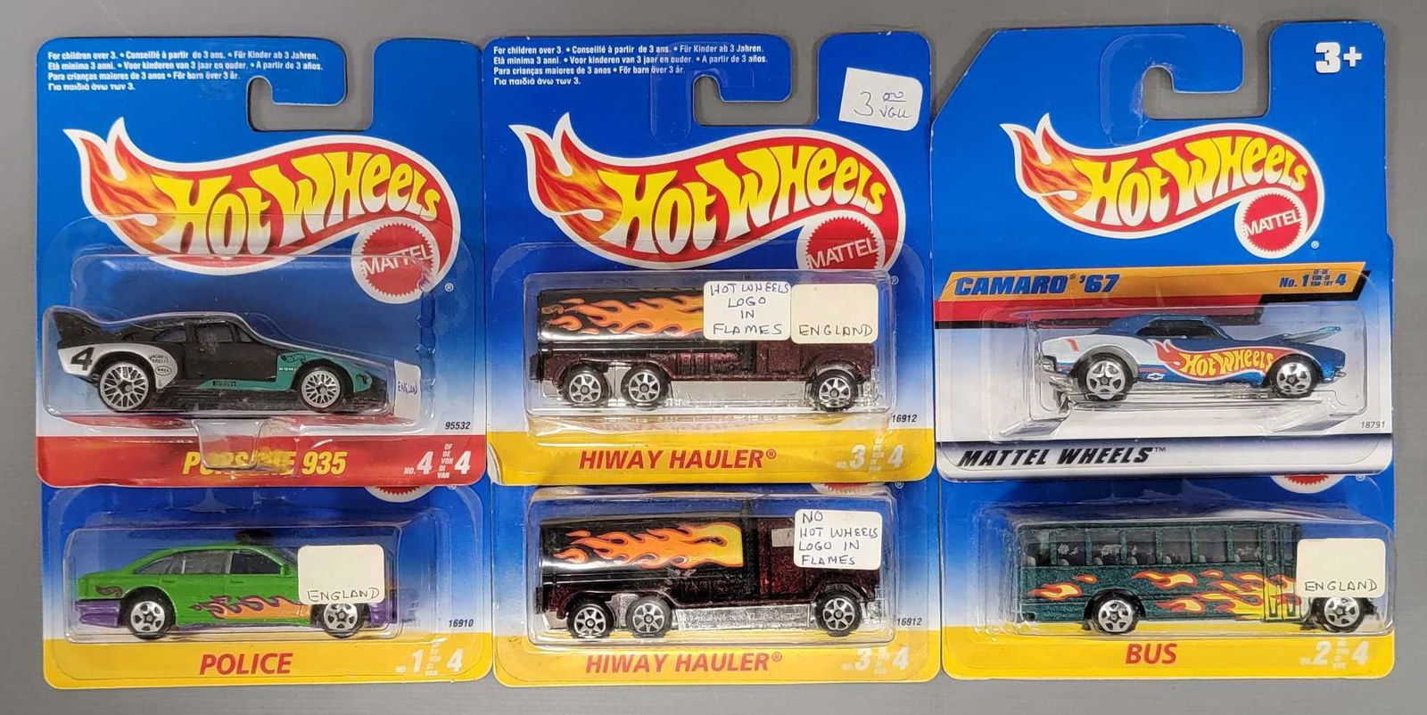 Six Hot Wheels International Short Cards: Six Hot Wheels International Short Cards. Porsche 935, Police, Bus, 67 Camaro, Hiway Hauler with the Hot Wheels logo in the fames and a Hiway Hauler without the Hot Wheels logo in the flames all mint