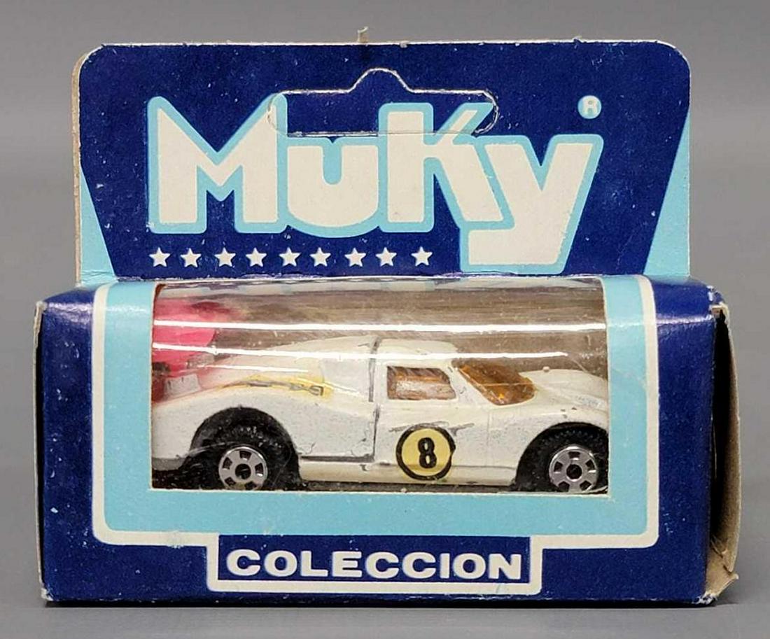 Muky 1/64 die cast white Ford Mk IV turbo in original box Hot Wheels clone: Muky 1/64 die cast white Ford Mk IV turbo in original box Hot Wheels clone, car has a number of small paint chips and also has a Mobilgas Pegasus decal on the hood with an 8 roundel and a red wing as