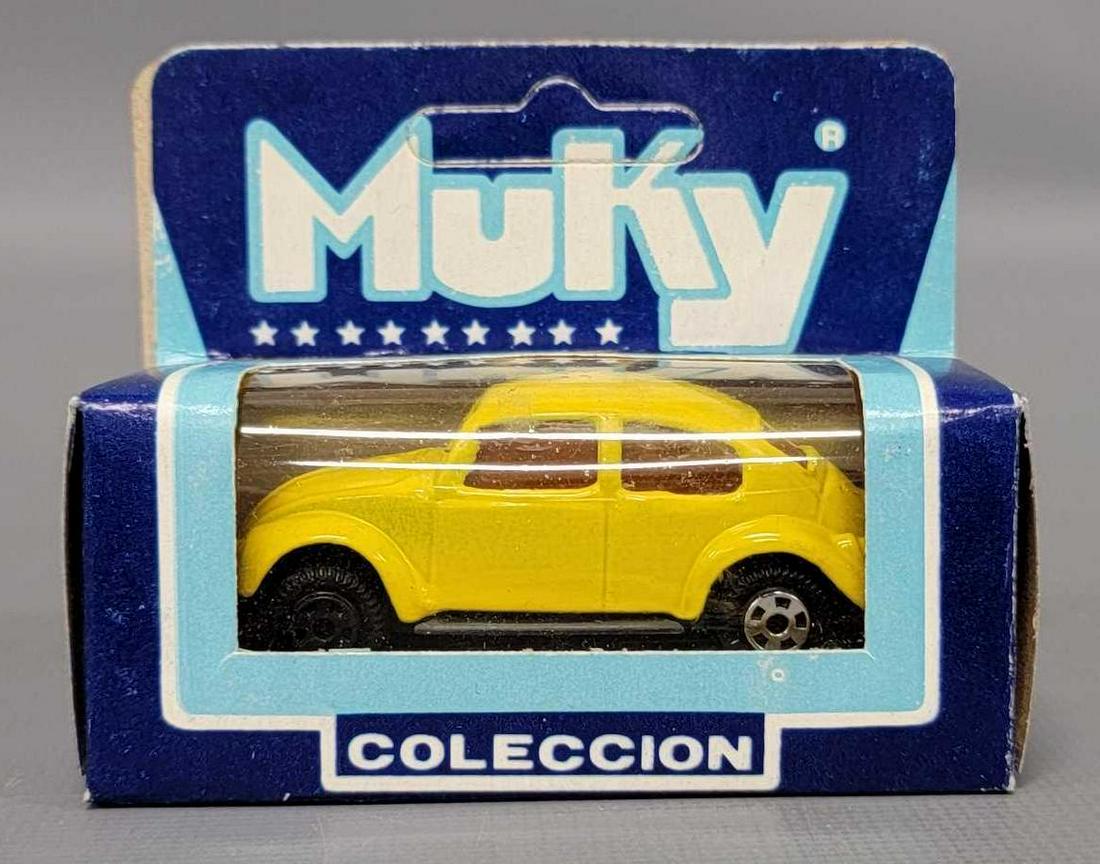 Muky 1/64 die cast yellow Volkswagen in original box Hot Wheels clone: Muky 1/64 die cast yellow Volkswagen in original box Hot Wheels clone, nice car with no paint wear but is missing all of the chrome off of the visible front wheel as seen in the photos.
