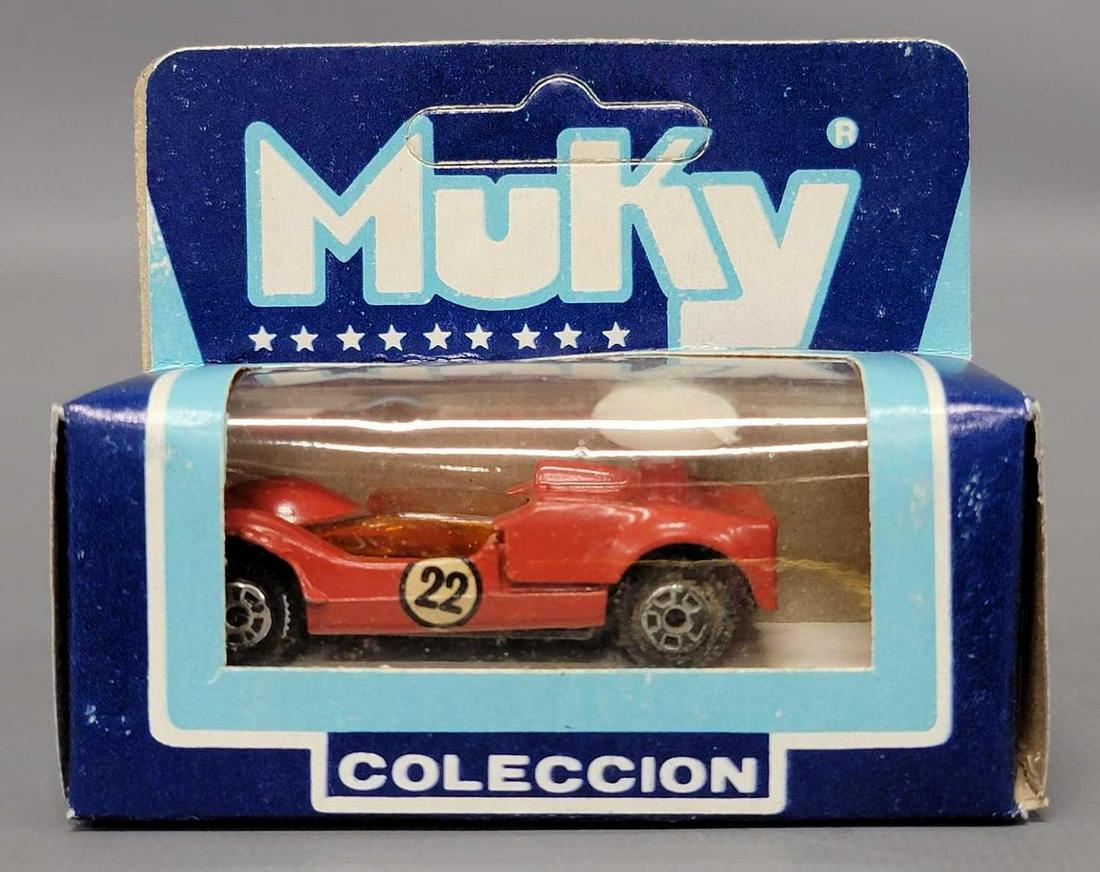 Muky 1/64 die cast red Chaparral 2G in original box Hot Wheels clone: Muky 1/64 die cast red Chaparral 2G in original box Hot Wheels clone, nice shape with 22 roundels on the sides.