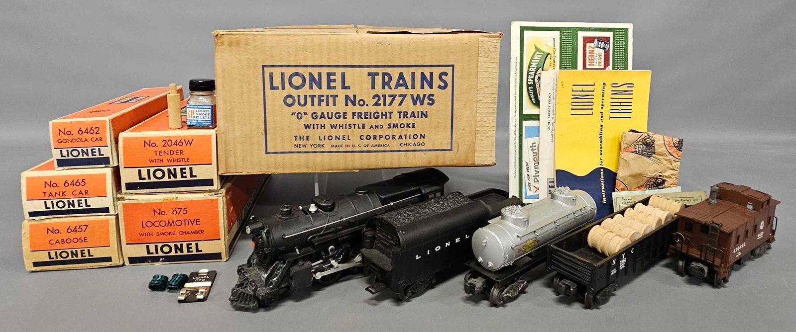 Gorgeous unrun box Lionel postwar O 2177WS steam freight set: Gorgeous unrun box Lionel postwar O 2177WS steam freight set to include 675 steam locomotive, 2046W tender, black 6462 gondola with six wooden barrels, 6465 Sunoco tank car and 6457 caboose, bottle of