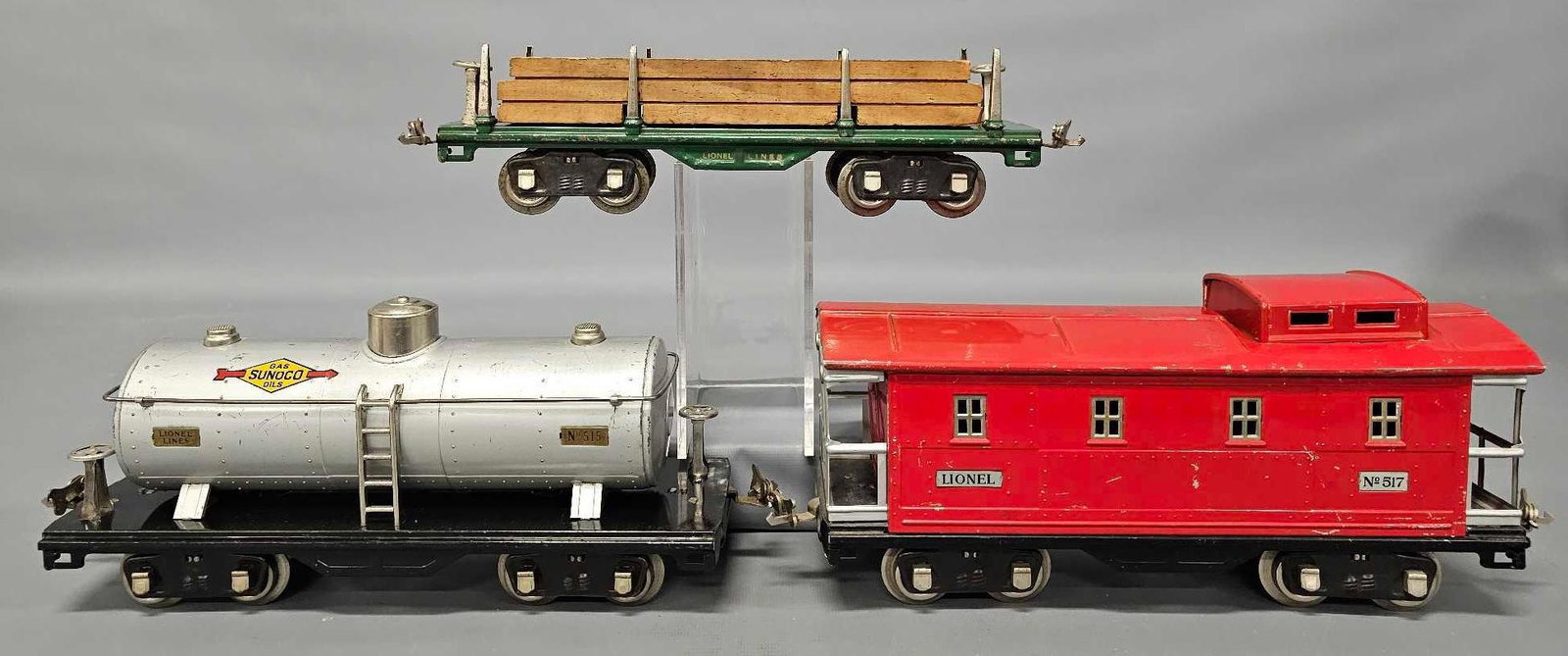Three Lionel prewar standard gauge 500 series freight cars with all nickel trim: Three Lionel prewar standard gauge 500 series freight cars with all nickel trim to include 515 tank car, 511 lumber car with original load and 517 caboose, C5-6 as seen in the photos.
