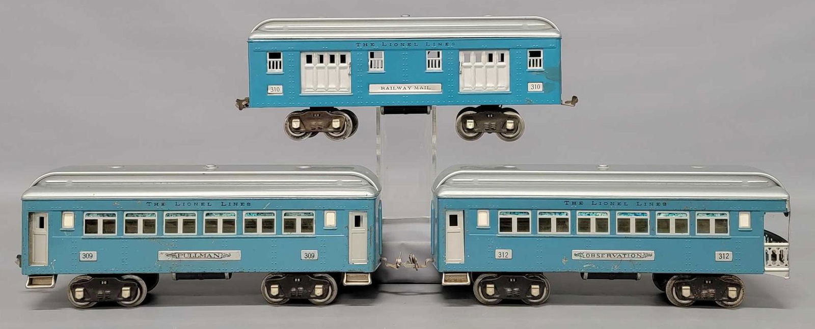 Lionel prewar standard gauge 309 310 312 blue and silver passenger cars: Lionel prewar standard gauge blue and silver passenger cars to include 309 coach, 310 baggage that has had some restoration and a tough up on one end plus a 312 observation car. Sold as-is as seen in