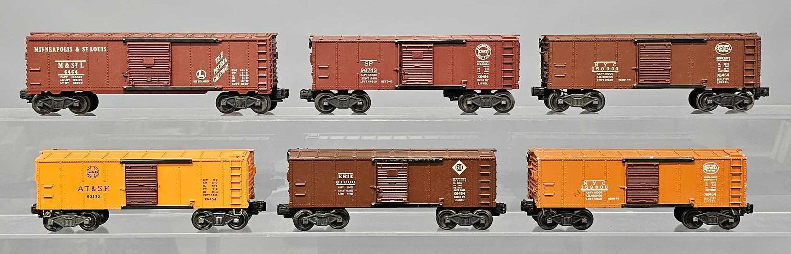 Six Lionel postwar O box cars: Six Lionel postwar O box cars to include 6464-50 Minneapolis & St. Louis, plus Erie, Santa Fe, Southern Pacific and two different New York Central 6454, C6 as seen in the photos.