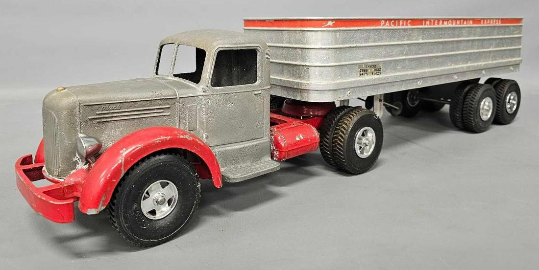 Customized Smith Miller L Mack PIE open tractor trailer: Customized Smith Miller L Mack PIE open tractor trailer. The trailer was made by cutting the top off of an enclosed trailer, the cab has been stripped and is unpainted, the wheels and tires are all re