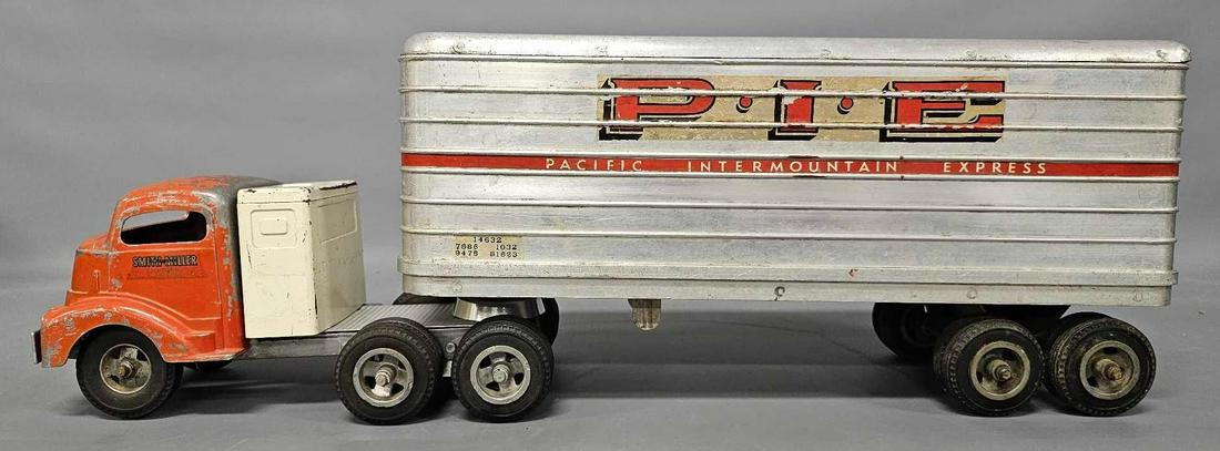 Customized Smith Miller GMC PIE semi tractor trailer: Customized Smith Miller GMC PIE semi tractor trailer. It has a sleeper added on along with a piece of diamond plate as well as a reproduction 5th wheel. The cab and trailer are all original as seen in