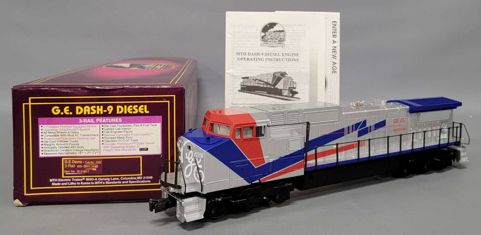 MTH Premier O gauge GE demonstrator Dash 9 diesel locomotive in original box 20-2160-1: MTH Premier O gauge GE demonstrator Dash 9 diesel locomotive in original box, stock number 20 2160 1, unrun and C9-10 in an excellent original box with original paperwork as seen in the photos.