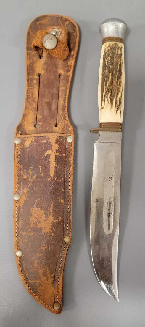 Stag handled knife with swastika in sheath: Stag handled knife with swastika in sheath. Knife is very sharp and has a 6 1/16 inch long blade, the handle is just over 4 inches long as seen in the photos.