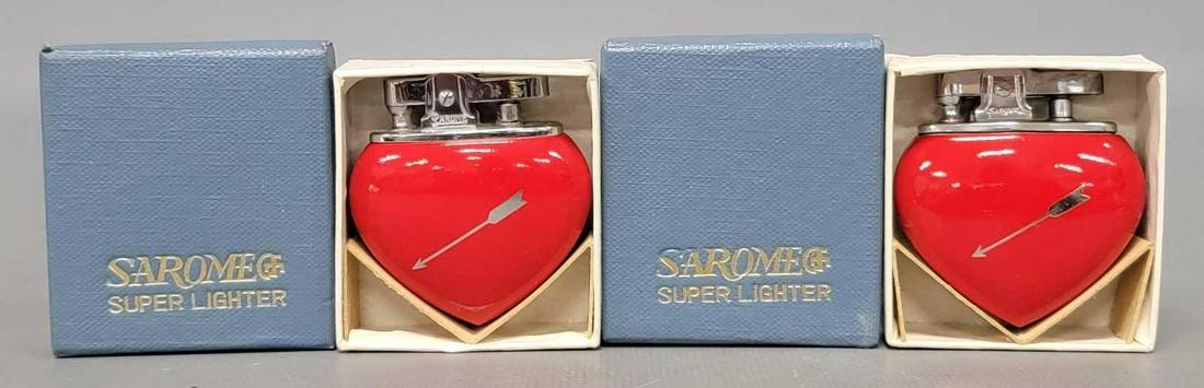 Two mint sarome heart shaped cigarette lighters in original boxes: Two mint sarome heart shaped cigarette lighters in original boxes, both are unused and mint in excellent original boxes as seen in the photos.