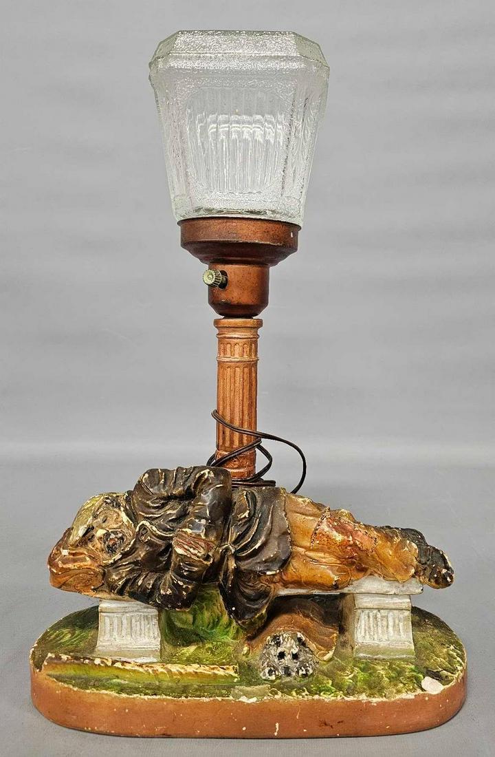 Vintage hobo or bum sleeping on a park bench chalkware lamp: Vintage hobo or bum sleeping on a park bench with his dog underneath chalkware lamp, 11 inches wide and almost 17 inches tall in good to very good condition as seen in the photos.