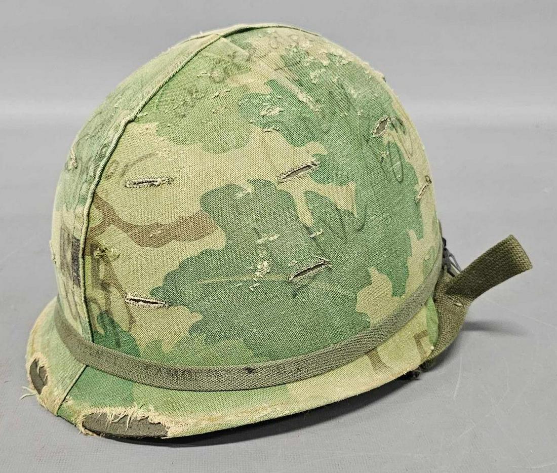 US Vietnam era M1 helmet with camouflage cover and graffiti with liner: US Vietnam era M1 helmet with camouflage cover and graffiti with liner, very cool but no provenance as seen in the photos.