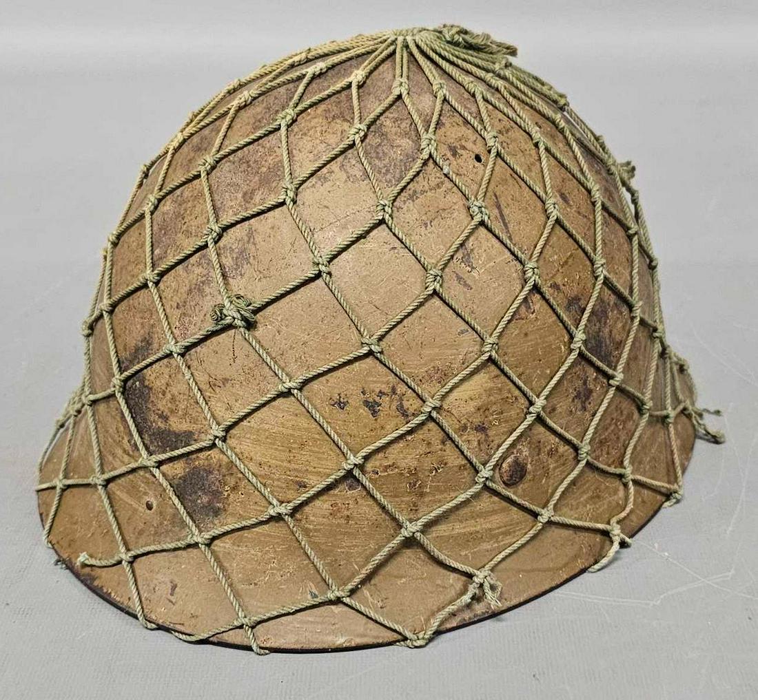 WWII battle damaged Japanese helmet with repro liner with netting: WWII battle damaged Japanese helmet with reproduction liner and netting, good condition as seen in the photos.