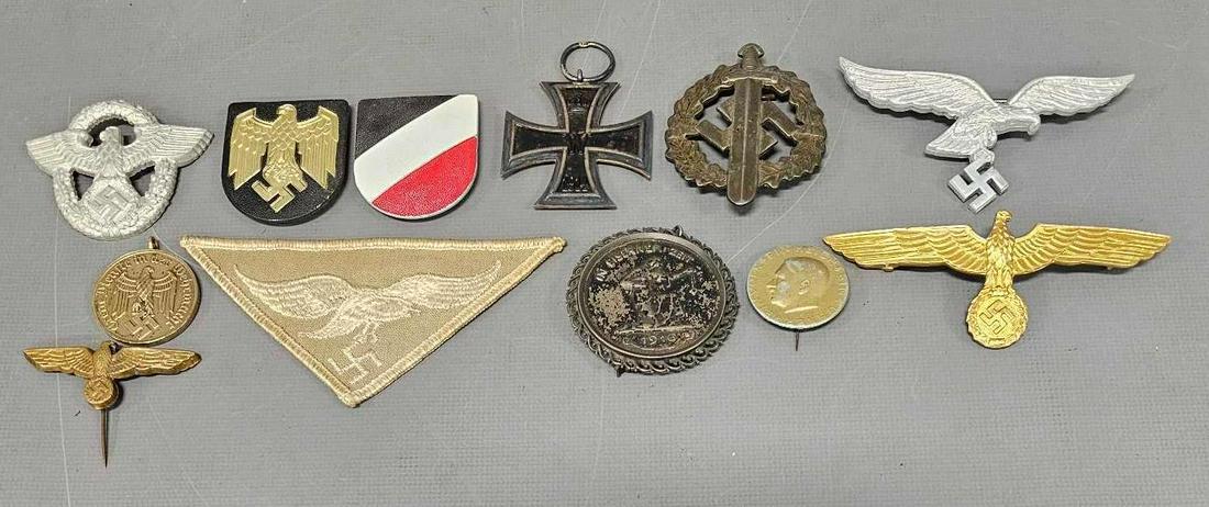 Nice group of WWI and WWII German tinnies medals and insignia: Nice group of WWII German tinnies medals and insignia highlights to include WWI 2nd class iron cross missing ribbon, Assmann Luftwaffe summer white breats eagle and a pair of shields for a Navy pith h