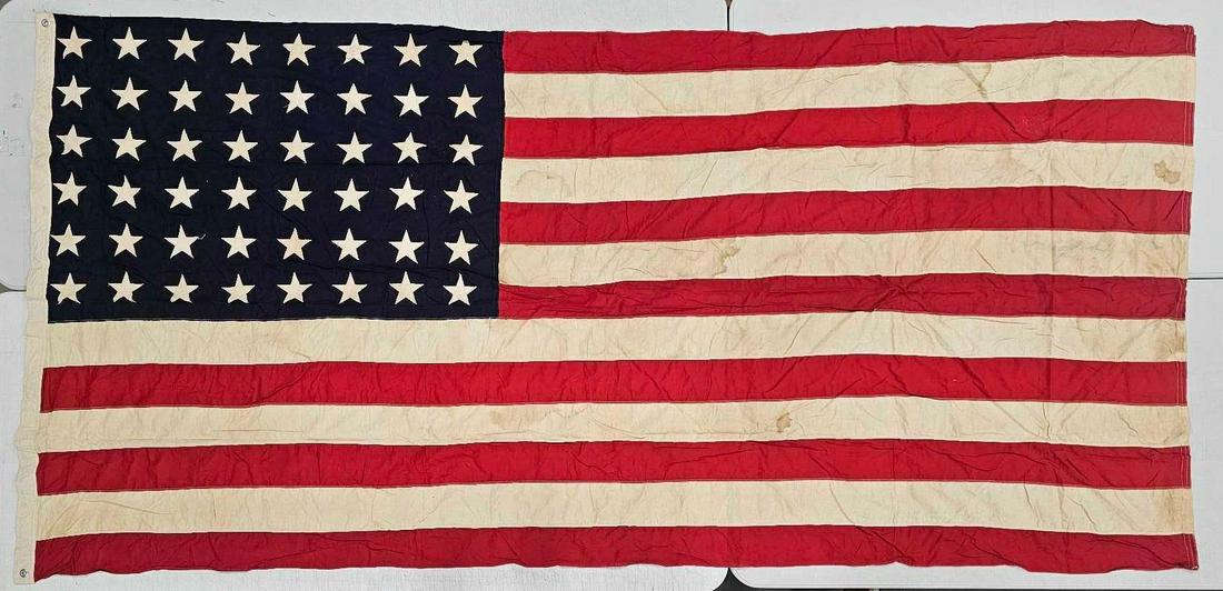 United Service Flag Co 48 star American flag: United Service Flag Co 48 star American flag with machine stitched stars, measures 111 inches x 56 inches OR 9 feet 3 inches by 4 feet 8 inches and is in very good condition with some stains as seen i