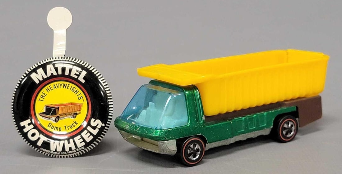Redline Hot Wheels The Heavyweights green Dump Truck with button: Redline Hot Wheels The Heavyweights green Dump Truck with button, truck has play wear such as paint chips and scratches on the windshield, has decent wheels and a very shiny base with an excellent met