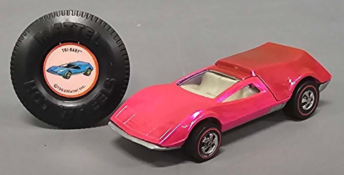 Redline Hot Wheels pink Tri Baby with button: Redline Hot Wheels pink Tri Baby with button. A super clean example with one tiny chip but does have even toning on the entire rear section, nice wheels and a minty plastic button as seen in the photo