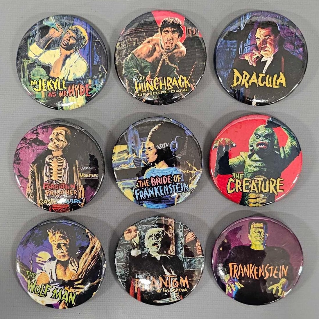 Nine Aurora Monsters pinback buttons with original box art: Nine Aurora Monsters pinback buttons with original box art, neat buttons that measure 2 1/8 inches in diameter and are Lionel Lines like new as seen in the photos.