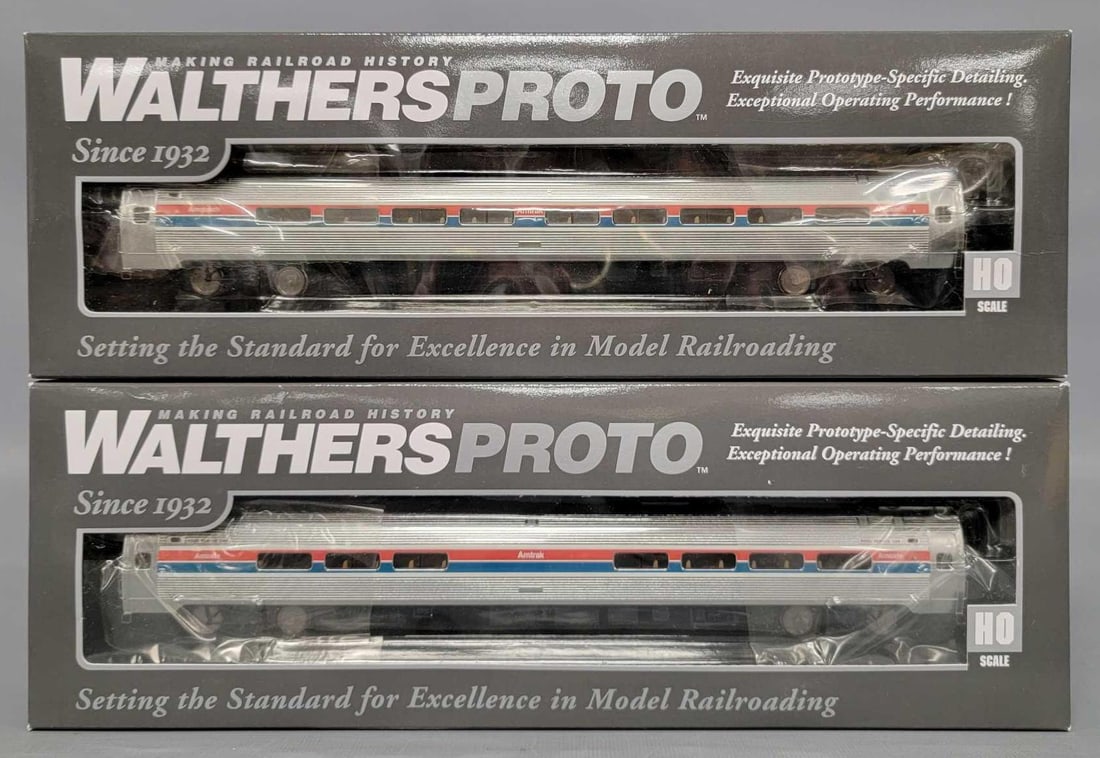 Two Walthers Proto HO Amtrak Phase 2 passenger cars in original boxes: Two Walthers Proto HO Amtrak Phase 2 passenger cars in original boxes to include stock number 11200 Amfleet I 84 seat coach and 11240 Amfleet I Amcafe car, C9-10 in very good original boxes with sligh