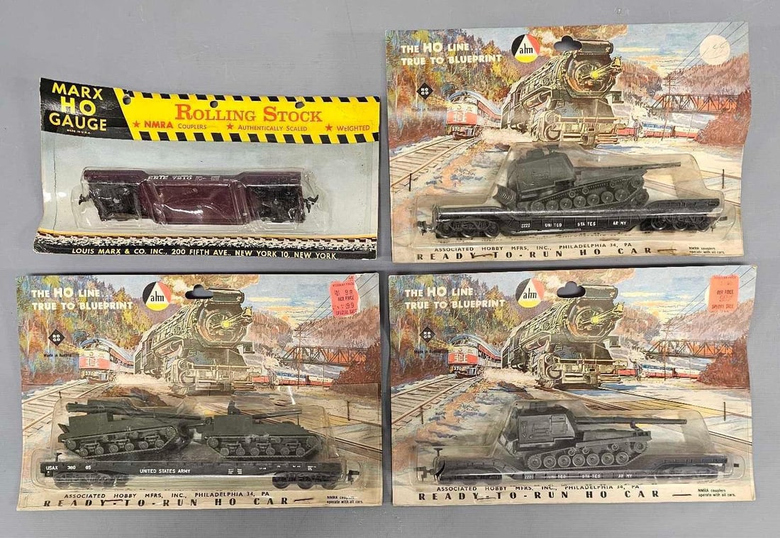 Three AHM US Army flat cars with armor loads and a Marx flat car in blister packs: Three AHM US Army flat cars with armor loads and a Marx flat car in blister packs. All four are new and unrun in good to very good packages as seen in the photos.