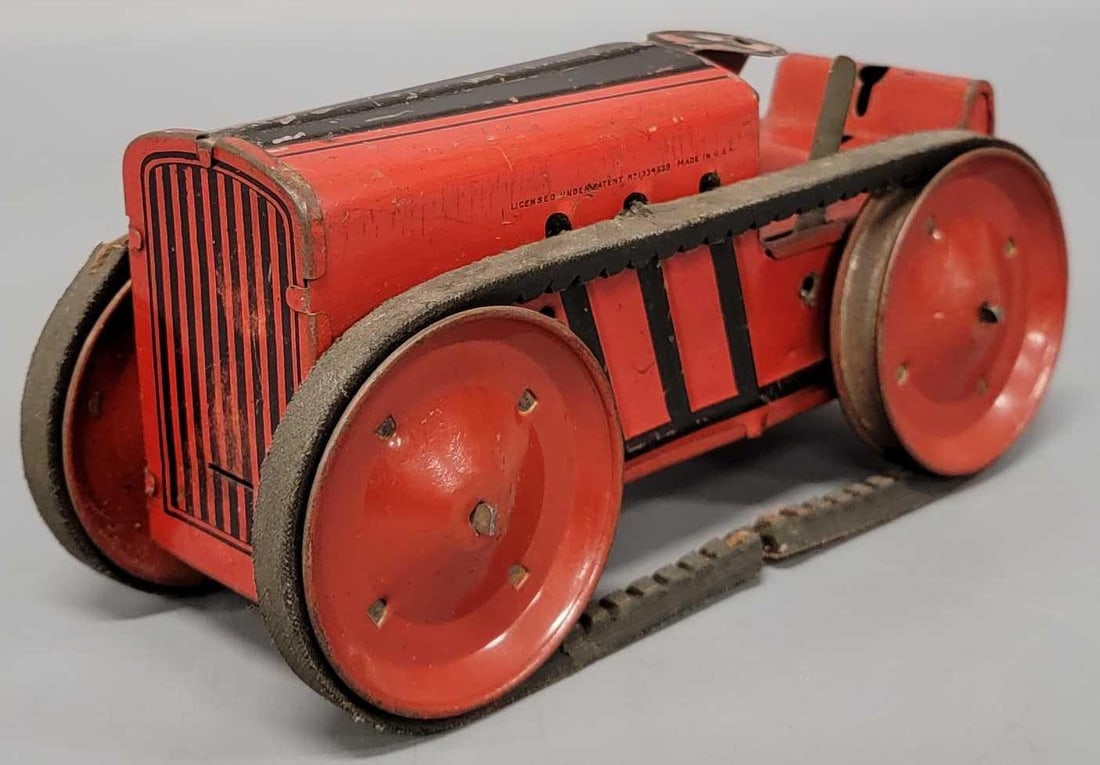 1930's Marx tin wind-up toy tractor: 1930s Marx tin wind-up toy tractor, does not work, needs the clockwork repaired, missing the figure that would have been on it, measures 8 1/4 inches long.