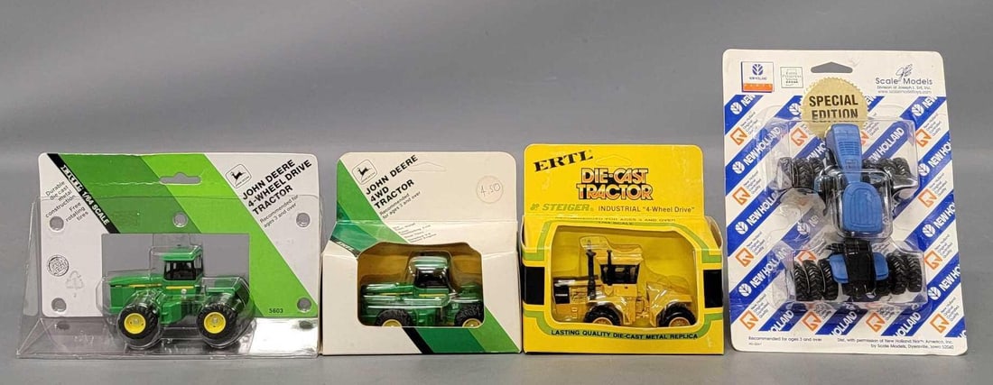 Group of four Ertl 1/64 4 WD die cast tractors: Group of four Ertl 1/64 4wheel drive die cast tractors in original box. Steiger Industrial 4WD die cast tractor stock number 1980, John Deere 8850 4WD tractor stock number 575, John Deere 8850 4WD tra
