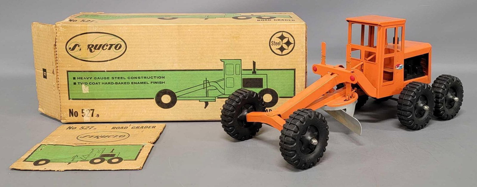 Near mint Structo pressed steel road grader in original box: Near mint Structo road grader in original box, superb example that is rarely seen in a complete original box that has two detached flaps from one end whereas the other end is still factory staple seal