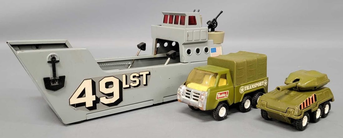 Buddy L pressed steel 49 LST landing craft and two military vehicles: Buddy L pressed steel 49 LST landing craft and two military vehicles. The LST looks nice but one of the plastic gins is broken but will stay in place as seen in the photos. The two smaller trucks are