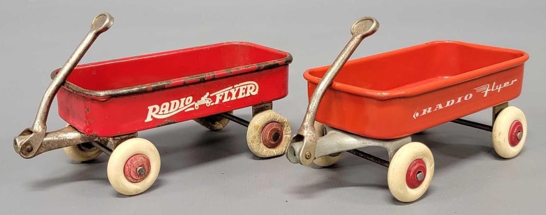 Two Radio Flyer miniature toy wagons: Two Radio Flyer miniature toy wagons, one marked HGT from the New York World's Fair with perfect wheels and the other with the Radio Flyer emblem that has two bad wheels. These measure 4 3/4 inbch