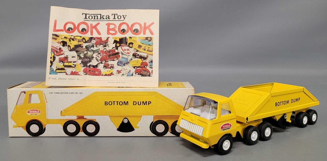 Mint Tiny Tonka pressed steel bottom dump in original box with look book 655: Mint Tiny Tonka pressed steel bottom dump in original box with look book, stock number 655. Truck is new old stock in an excellent original box with a crisp look book as seen in the photos.